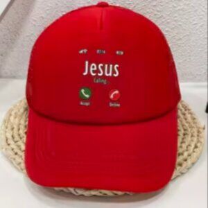 Red cap unisex with " Jesus is calling " on the front .
